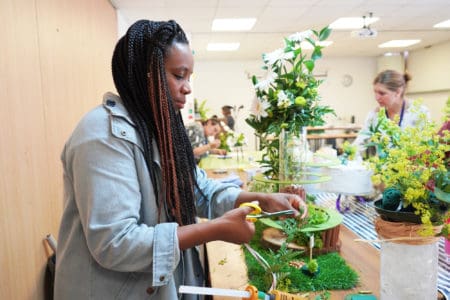 Floral student creating a design at Capel Manor College