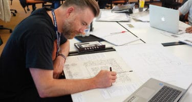 Man drawing a gardens design plan