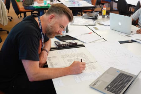Man drawing a gardens design plan