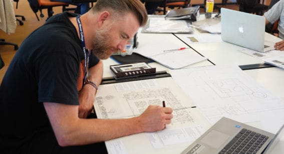 Man drawing a gardens design plan