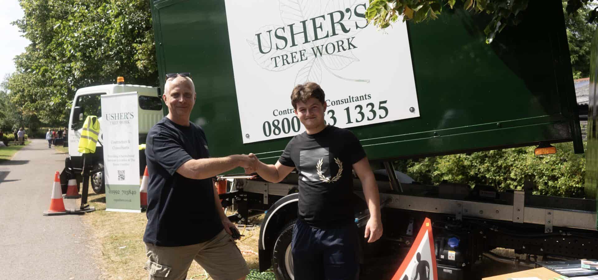 Capel Manor College apprentice shaking hands with a member of staff from new employer - Usher's Tree Work.