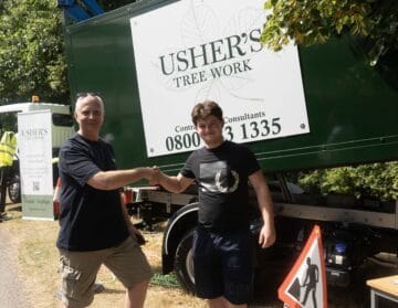 Capel Manor College apprentice shaking hands with a member of staff from new employer - Usher's Tree Work.