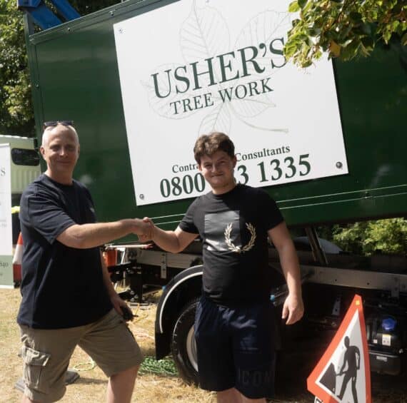 Capel Manor College apprentice shaking hands with a member of staff from new employer - Usher's Tree Work.