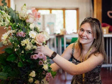 Floristry Student Working on a Bouquet of Flowers at Capel Manor College's Enfield Campus.