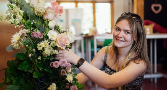 Floristry Student Working on a Bouquet of Flowers