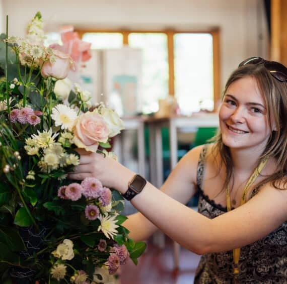 Floristry Student Working on a Bouquet of Flowers