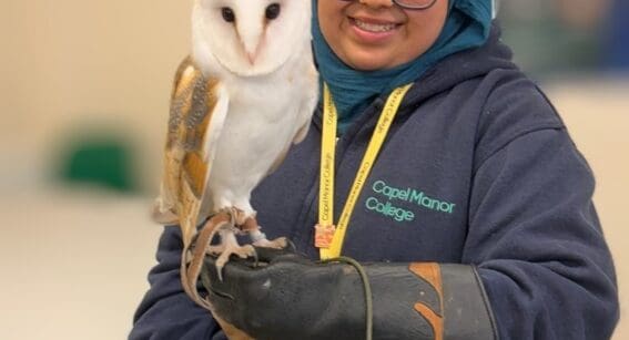 Capel Manor College animal management student, Aisha, holding an owl.