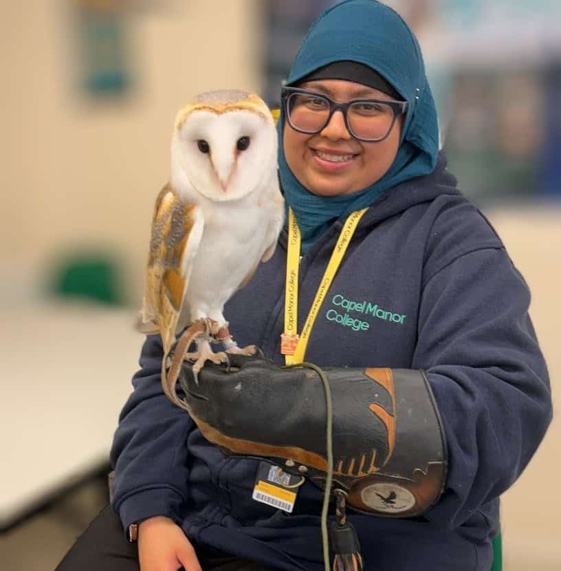 Capel Manor College animal management student, Aisha, holding an owl.