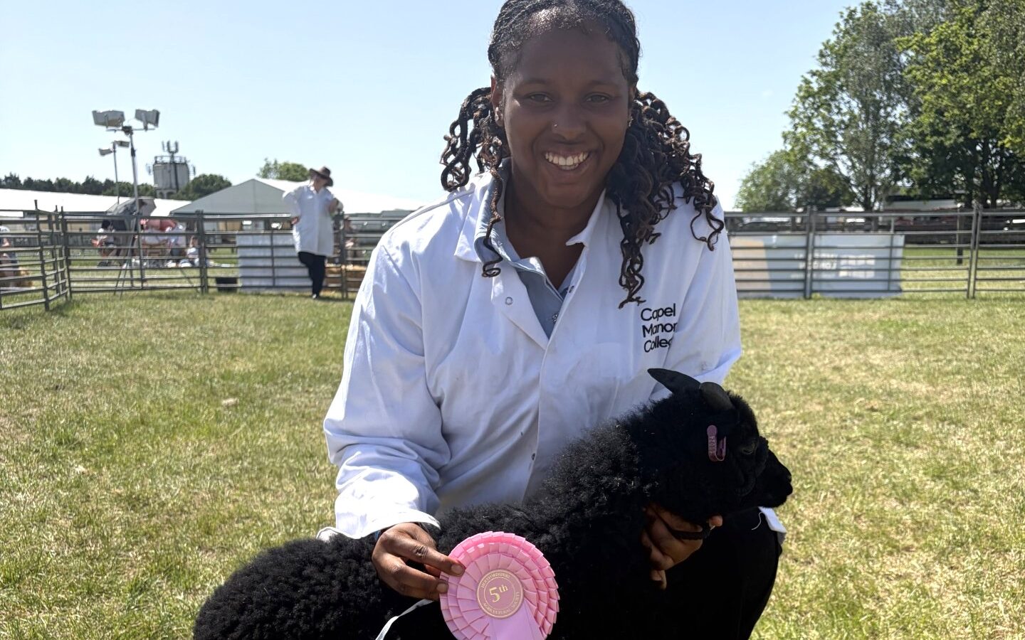 Agriculture student at Capel Manor College showing a sheep with a rosette
