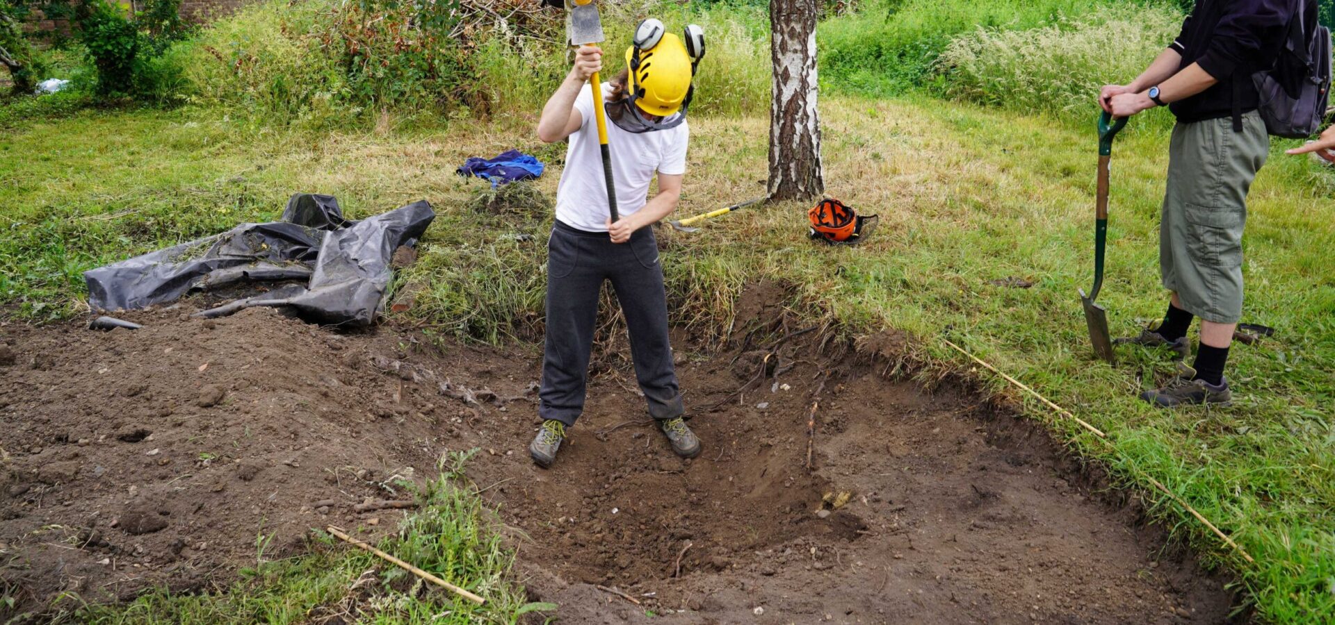 Wildlife and environmental conservation student from Capel Manor College digging a hole during a practical session