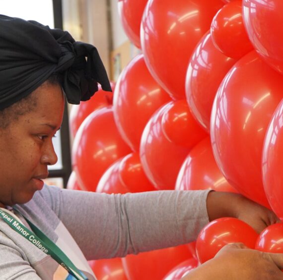 Balloon artistry student at Capel Manor College creating a display.
