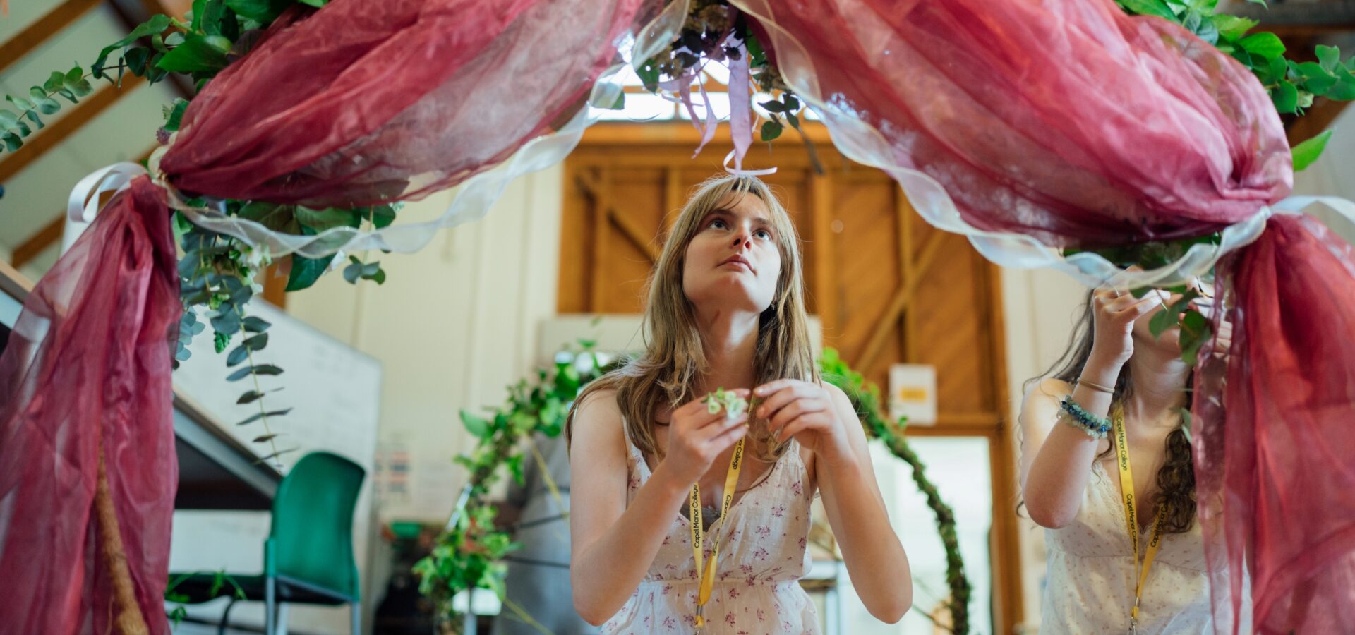 Floristry student at Capel Manor College creating a hoop display.