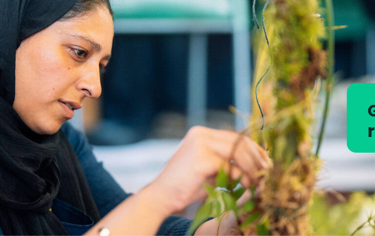 An art and design student at Capel Manor College creating a piece of art using natural materials.