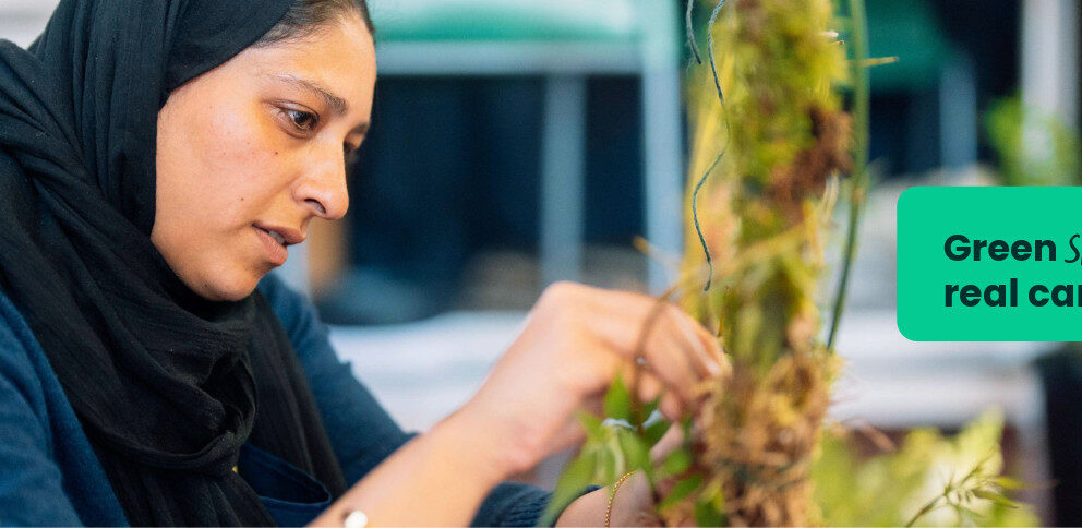 An art and design student at Capel Manor College creating a piece of art using natural materials.
