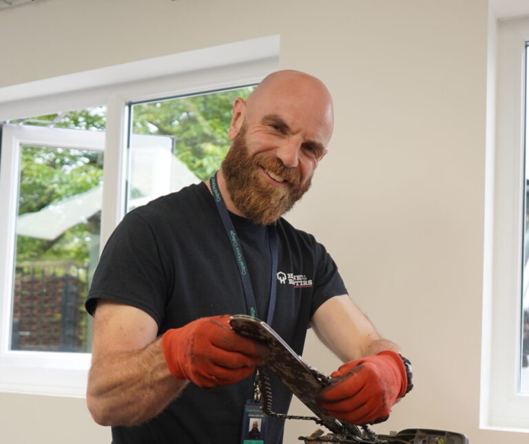 Adult arboriculture student at Capel Manor College with a chainsaw.