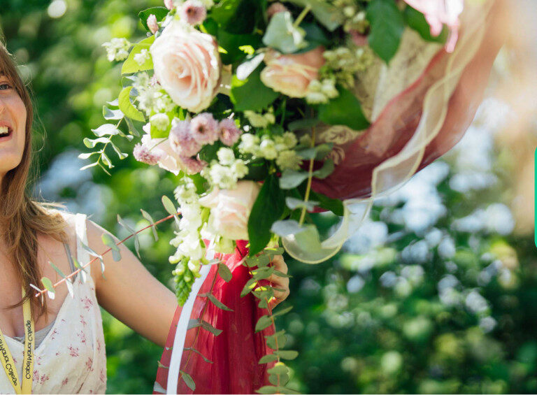 A floristry student at Capel Manor College putting a floral display up outside in the grounds of the Enfield Campus.