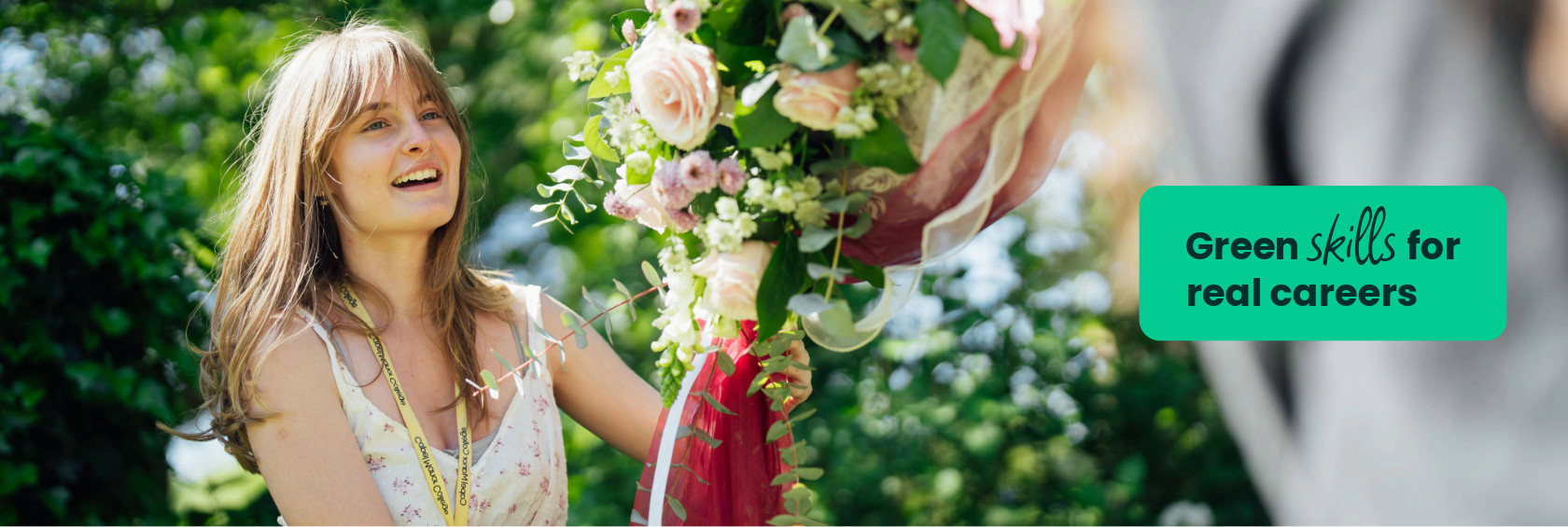 A floristry student at Capel Manor College putting a floral display up outside in the grounds of the Enfield Campus.