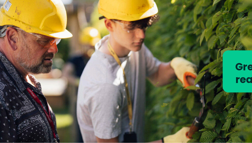 A horticulture student at Capel Manor College being observed by a tutor during a practical session.