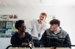 Three students at Capel Manor College chatting together during a horticulture lesson.