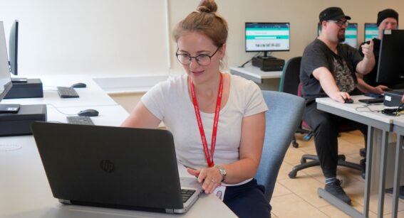 A student studying business and digital skills at a computer at Capel Manor College in London.