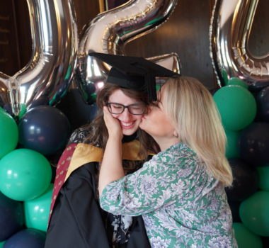 A parent congratulating an animal management higher education graduate at Capel Manor College in London.